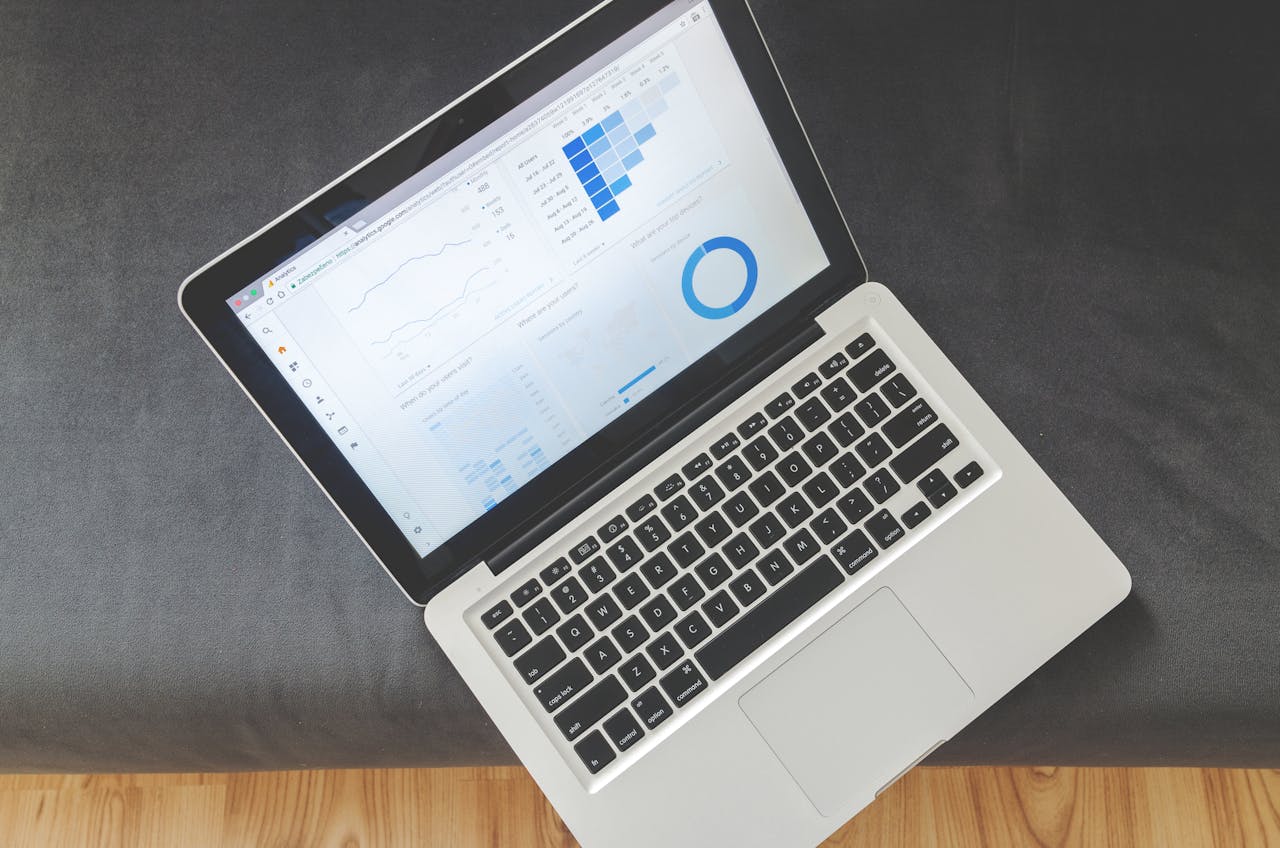 cta-bg Overhead view of a laptop showing data visualizations and charts on its screen.