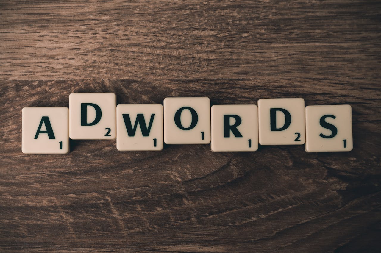 home-services-01 Scrabble tiles spelling 'AdWords' on a wooden surface, symbolizing digital marketing concepts.
